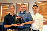 Technica USA receives the Representative of the Year Award from Harry H. Yun (L), General Manager, Koh Young America.